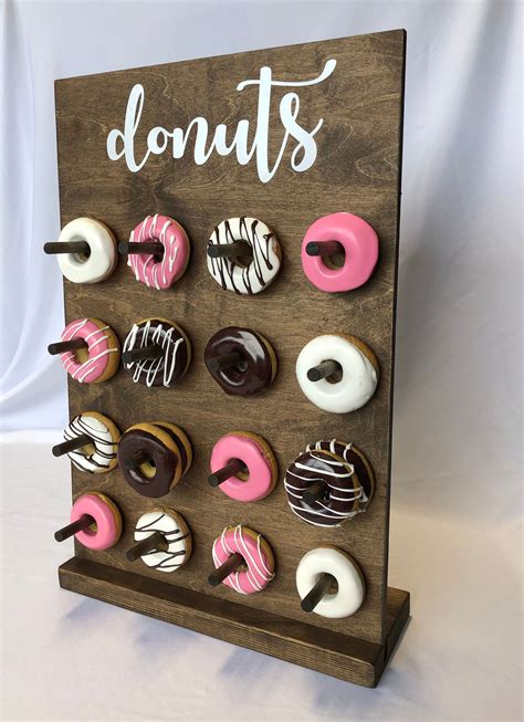 Donut stand - Donut Wall Stand, White 10mm waterproof plastic, Doughnut wall, Donut Stand. Framed Donut Design. Various Size Options Available, Holds from 9 to 96 Donuts The wall pictured Holds 35 to 70 Donuts Each Peg holds 1 or 2 Donuts Available in the following sizes: Holds 9 to 18 Donuts Holds 20 to 40 Donuts Holds 35 to 70 Donuts …